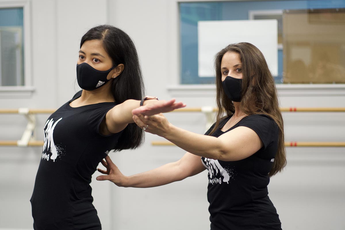 Kim helping a dance student